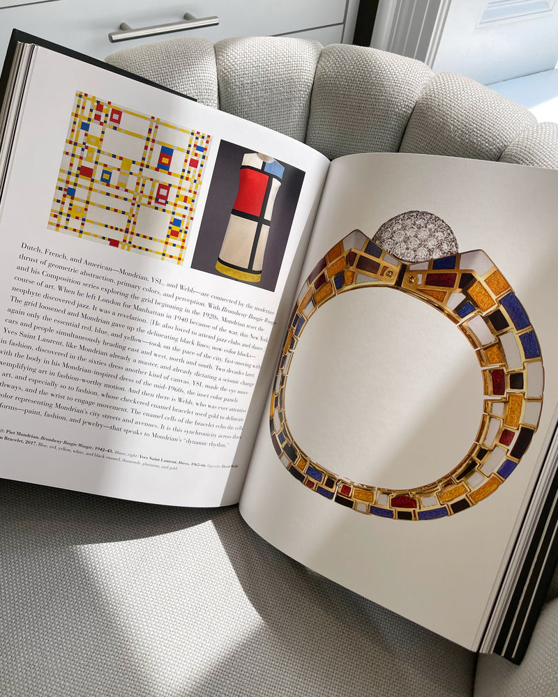 open coffee table book with pages showing art grid pattern designs in fashion and jewelry