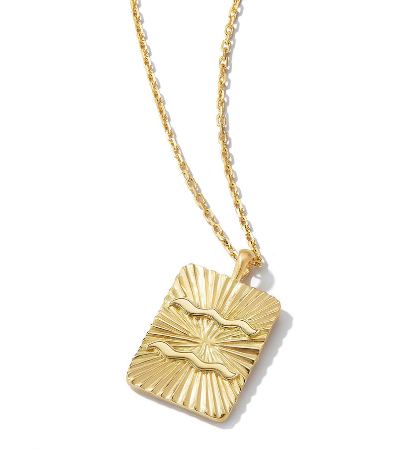 gold pendant with Aquarius zodiac sign on 18k gold chain necklace shown against white background
