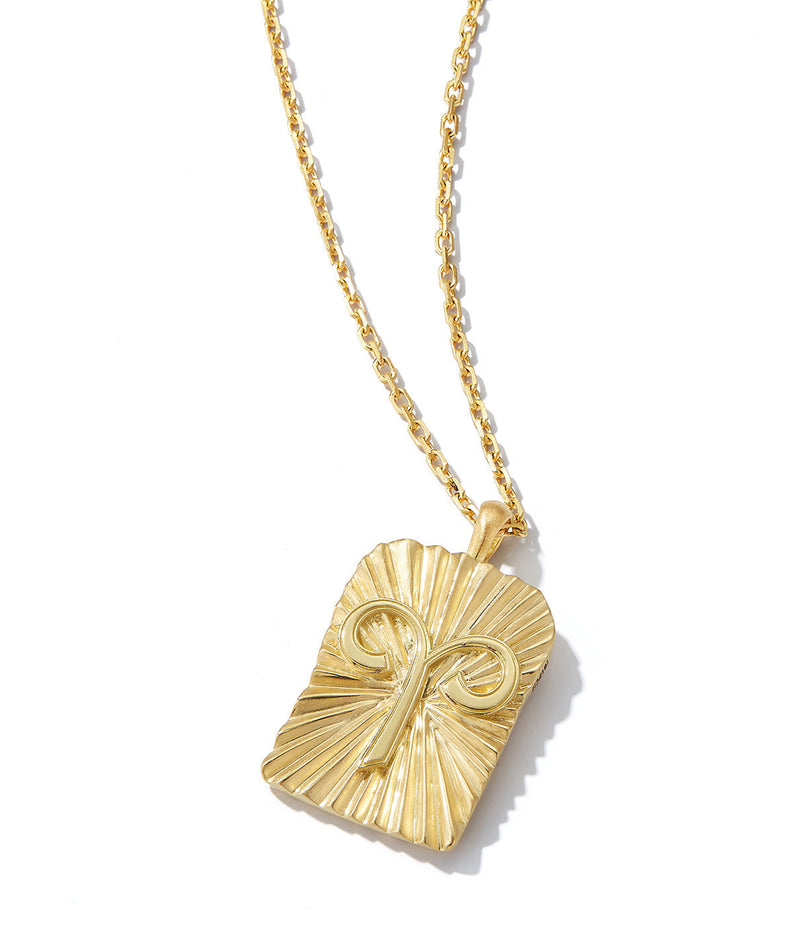 gold pendant with Aries zodiac sign on 18k gold chain shown close up against white background