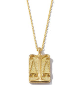 Libra zodiac pendant with gold scales design front side on 18k gold chain necklace shown close up