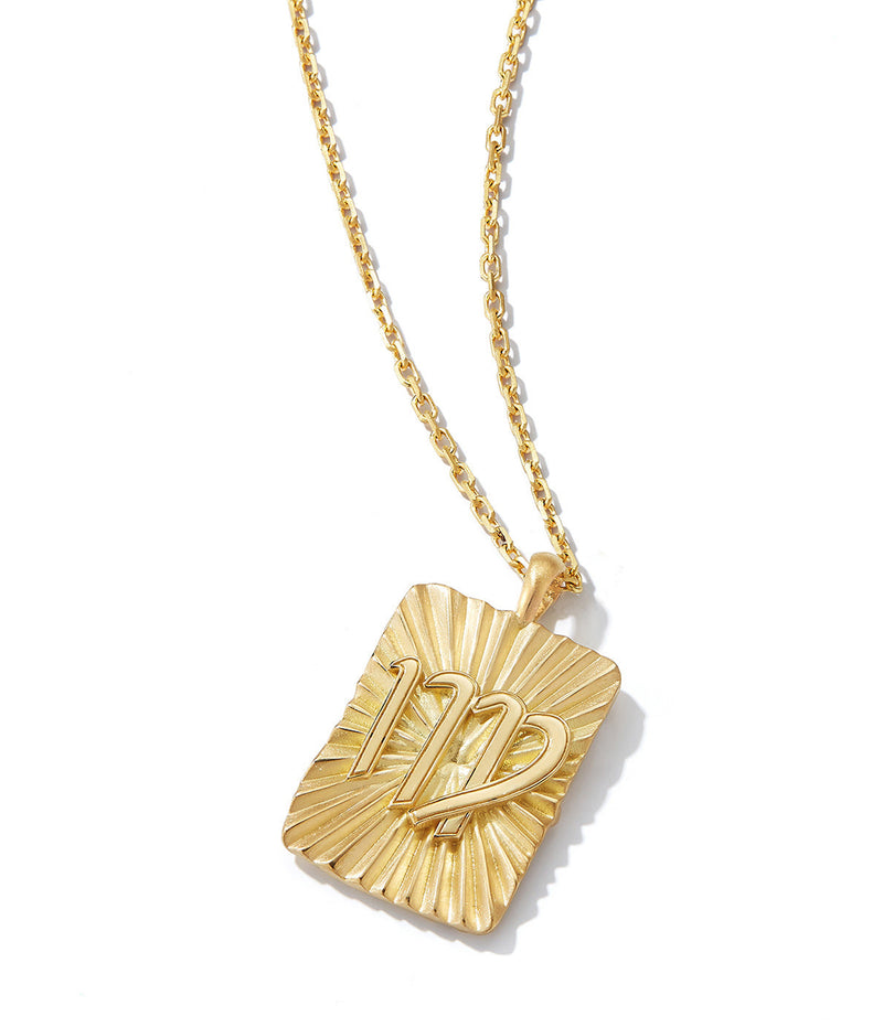gold pendant with Virgo zodiac sign on 18k gold chain necklace shown against white background